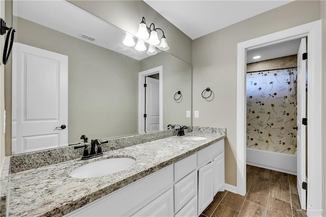 bathroom featuring vanity, hardwood / wood-style flooring, and shower / tub combo with curtain