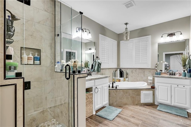 bathroom with vanity and plus walk in shower