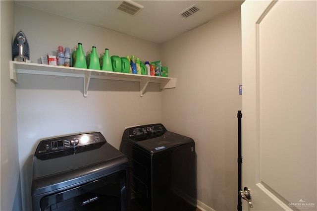 laundry room with separate washer and dryer