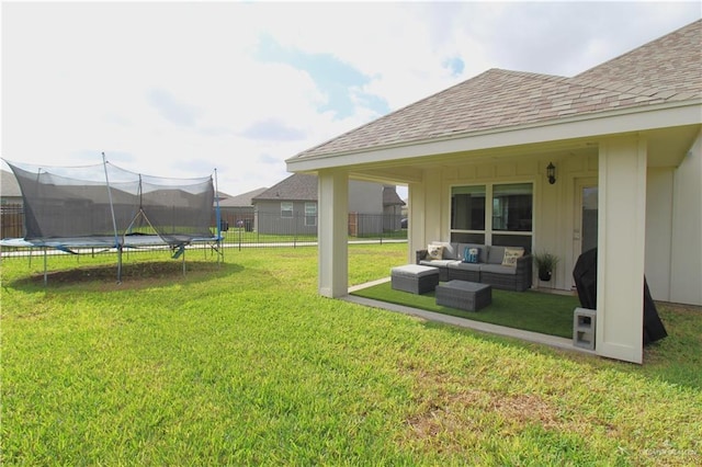 view of yard featuring an outdoor living space and a trampoline