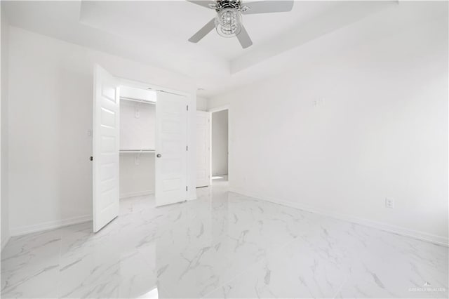 2620 Stevia Dr, Weslaco, TX 78596 - unfurnished bedroom featuring marble finish floor, baseboards, a closet, and a raised ceiling