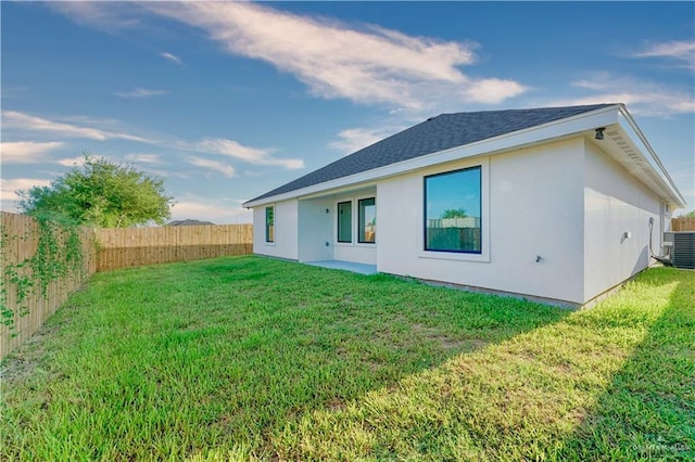 2620 Stevia Dr, Weslaco, TX 78596 - rear view of property with a fenced backyard, roof with shingles, cooling unit, and a lawn