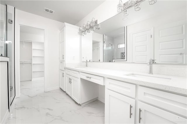 2620 Stevia Dr, Weslaco, TX 78596 - bathroom with a spacious closet, marble finish floor, and a sink