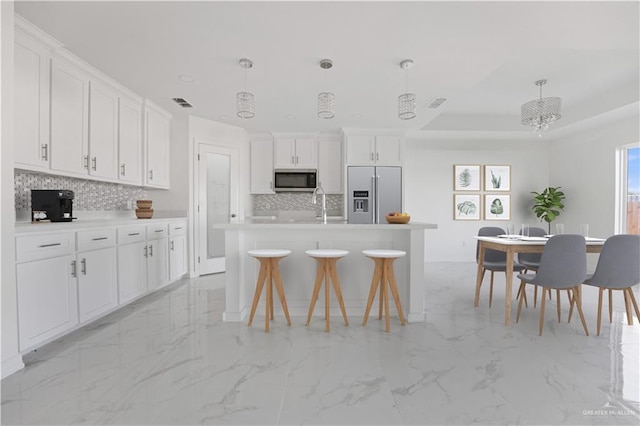 2620 Stevia Dr, Weslaco, TX 78596 - kitchen featuring marble finish floor, tasteful backsplash, stainless steel appliances, and white cabinets