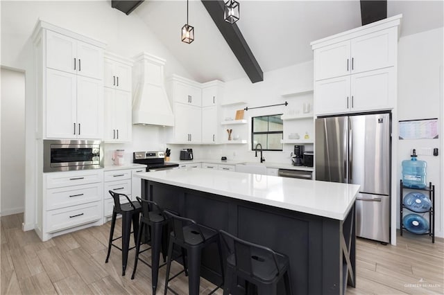 kitchen featuring stainless steel appliances, light countertops, custom exhaust hood, open shelves, and a kitchen bar