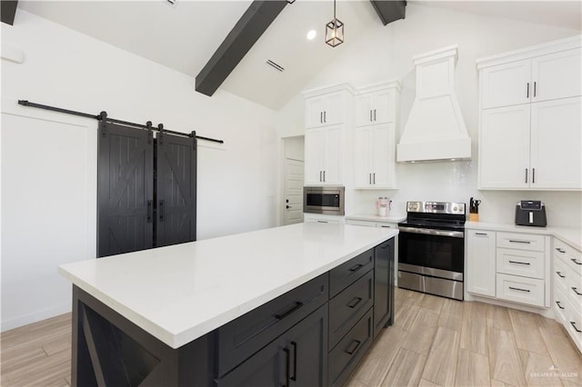 kitchen featuring white cabinets, custom range hood, stainless steel appliances, and light countertops