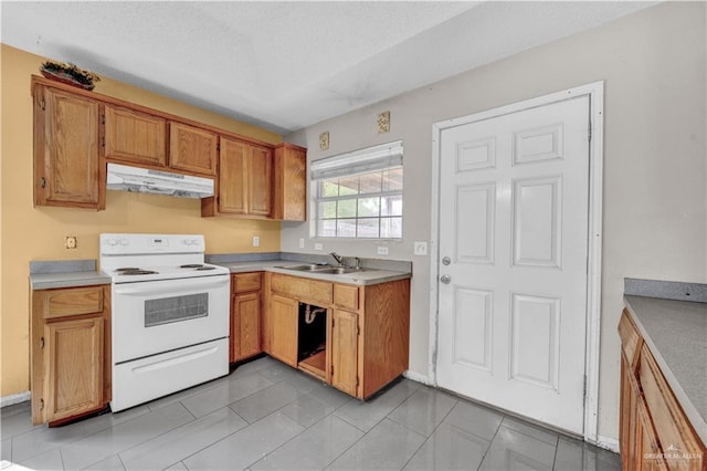 1101 Boston St, Edinburg, TX 78541 - kitchen featuring a sink, a textured ceiling, light countertops, under cabinet range hood, and electric stove