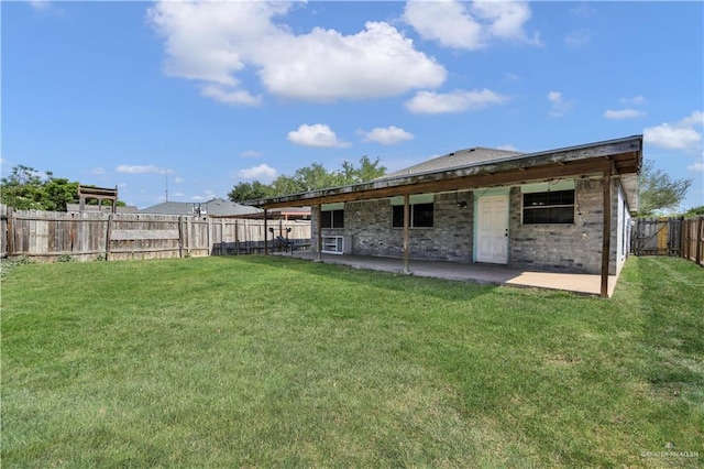 1101 Boston St, Edinburg, TX 78541 - rear view of property with a lawn, brick siding, a patio area, and a fenced backyard