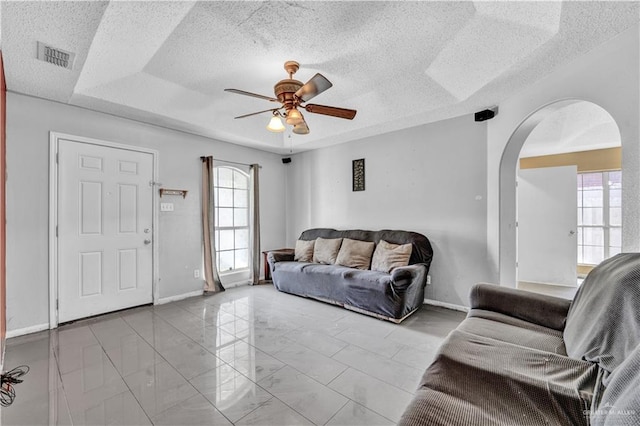 1101 Boston St, Edinburg, TX 78541 - living area featuring arched walkways, a healthy amount of sunlight, a ceiling fan, and visible vents