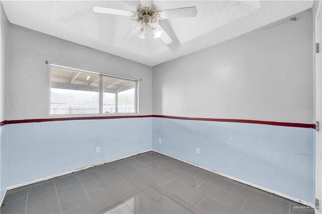 1101 Boston St, Edinburg, TX 78541 - tiled spare room with a ceiling fan, baseboards, and a textured ceiling