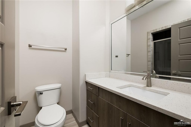 3302 S Sugar Rd Unit E, Edinburg, TX 78539 - bathroom featuring toilet, vanity, and baseboards