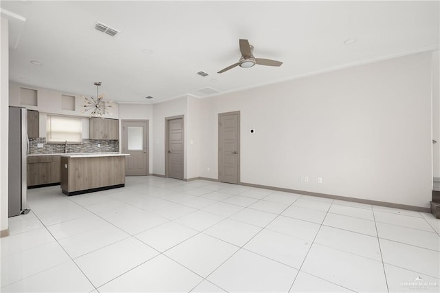 3302 S Sugar Rd Unit E, Edinburg, TX 78539 - kitchen featuring freestanding refrigerator, light countertops, decorative backsplash, a kitchen island, and ceiling fan
