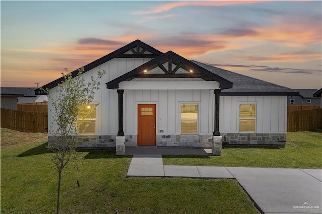 view of front facade featuring a lawn and covered porch