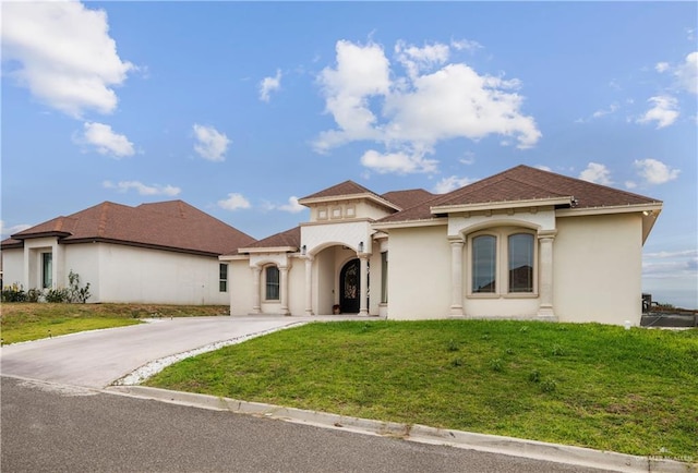 mediterranean / spanish house with a front lawn