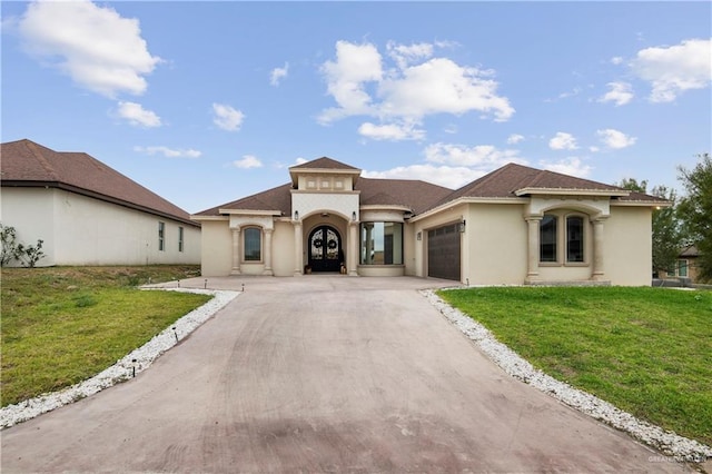 mediterranean / spanish home with a garage and a front lawn