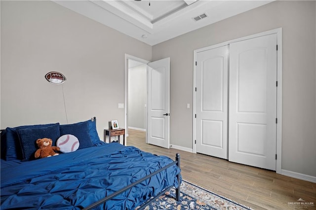 bedroom with wood-type flooring and a closet