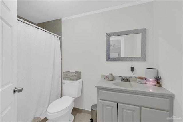 bathroom with toilet, vanity, and ornamental molding