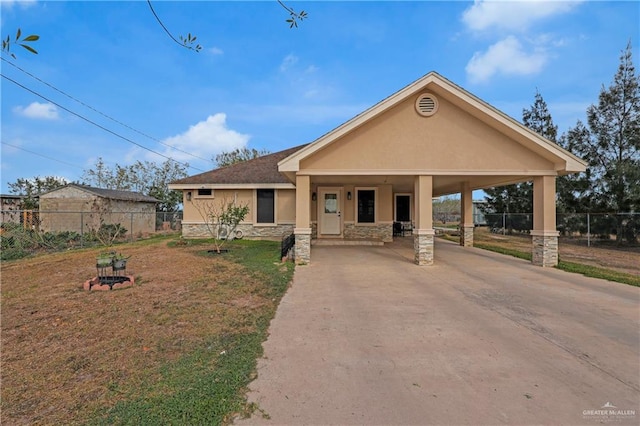 view of front of home featuring fence, stucco siding, concrete driveway, a front lawn, and stone siding