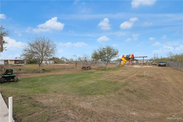 view of yard featuring fence and a playground