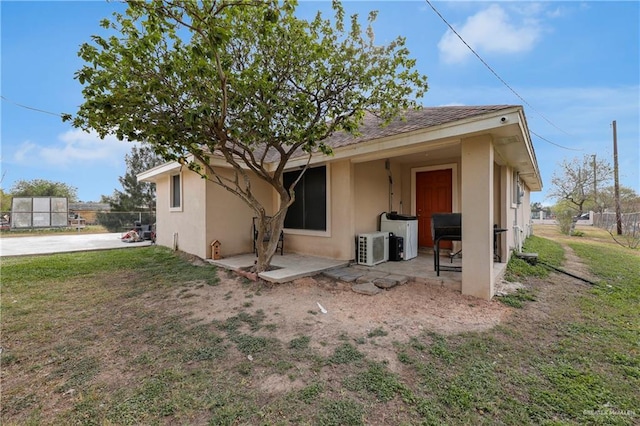 back of property featuring a patio area, fence, and stucco siding