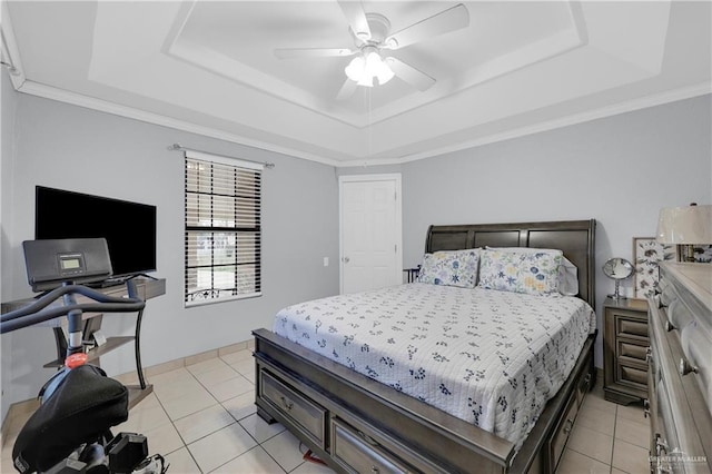 bedroom with light tile patterned floors, crown molding, and a raised ceiling