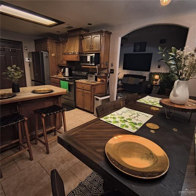 3312 Sanoma Dr, Weslaco, TX 78599 - dining space with light tile patterned floors and arched walkways