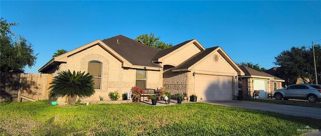 3312 Sanoma Dr, Weslaco, TX 78599 - view of front of property with a garage, concrete driveway, and brick siding