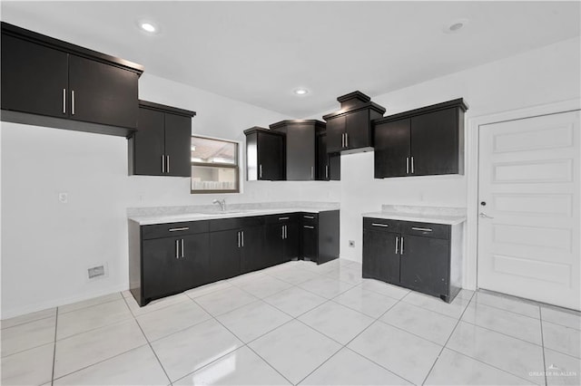 kitchen featuring light tile patterned flooring and sink