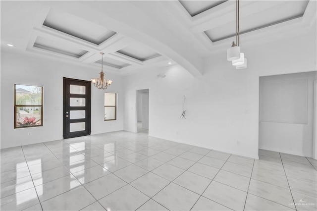 tiled empty room featuring coffered ceiling, beamed ceiling, a towering ceiling, and a notable chandelier