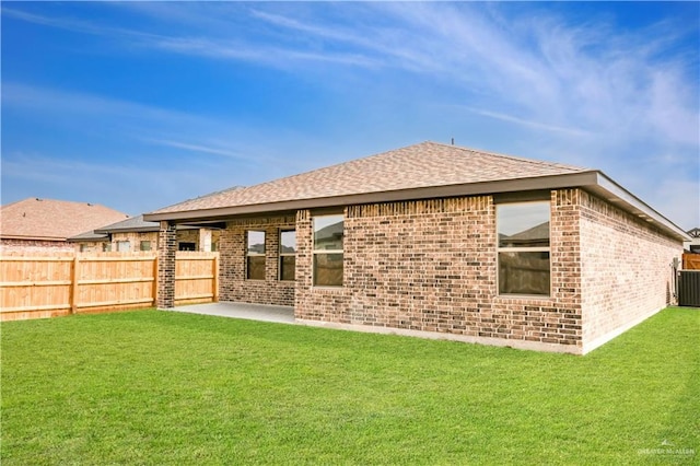 rear view of house with a patio area and a lawn