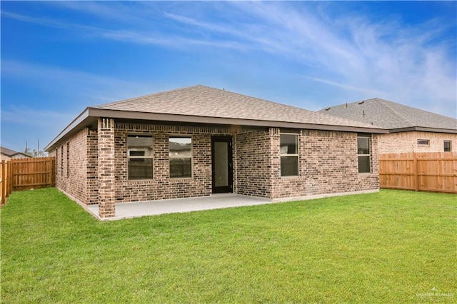 rear view of house with a patio and a lawn