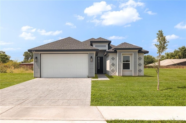 view of front facade with a front yard and a garage