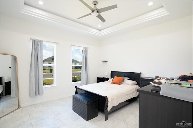 bedroom with a tray ceiling and ceiling fan