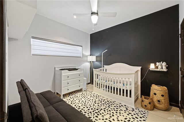 813 Travis St Unit 203, Mission, TX 78572 - bedroom with tile patterned flooring, ceiling fan, and a crib