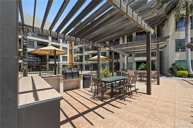 813 Travis St Unit 203, Mission, TX 78572 - view of patio with a pergola, an outdoor kitchen, and outdoor dining space