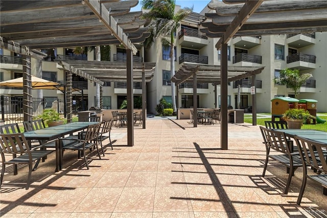 813 Travis St Unit 203, Mission, TX 78572 - view of patio / terrace featuring outdoor dining area and a pergola