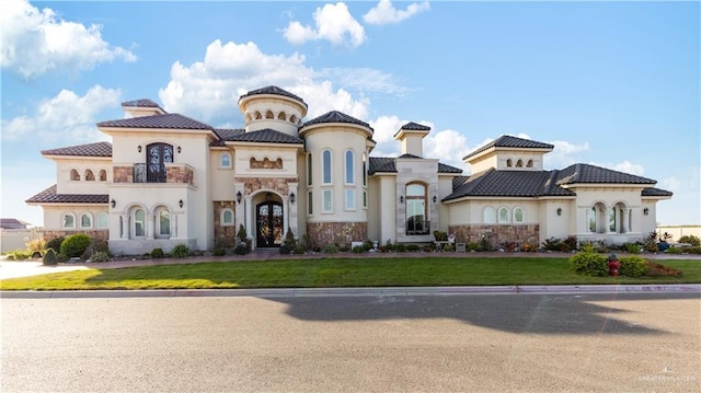 mediterranean / spanish-style house with a balcony and a front yard