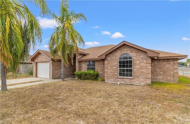 ranch-style house with a garage and a front lawn