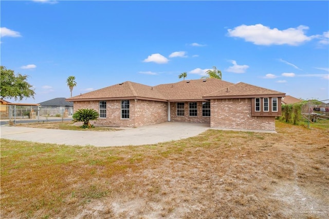 rear view of house with a lawn