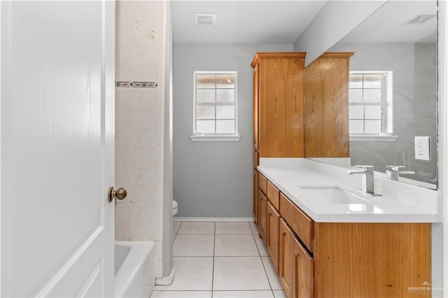 bathroom featuring tile patterned flooring, vanity, and toilet