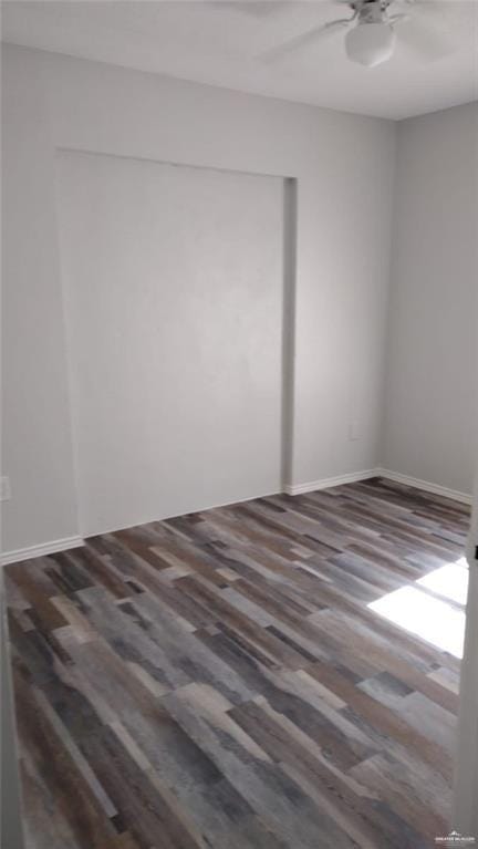 unfurnished room with dark hardwood / wood-style floors and ceiling fan