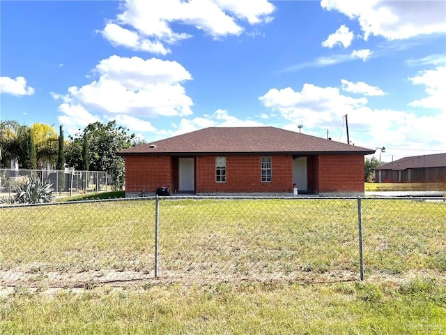 rear view of house with a yard