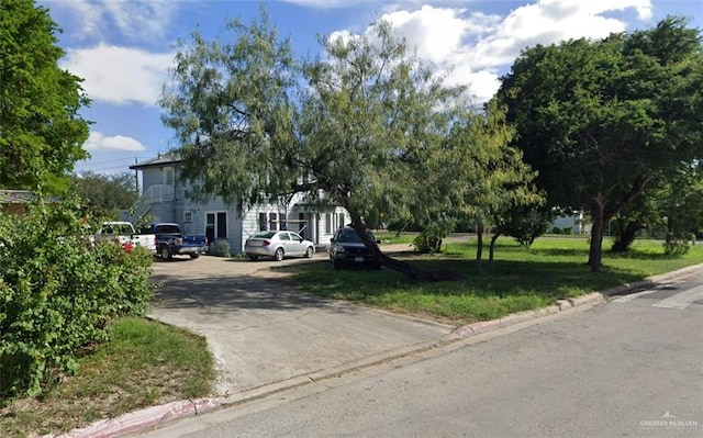 obstructed view of property featuring a front yard