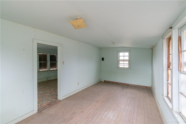 empty room featuring light hardwood / wood-style flooring and lofted ceiling