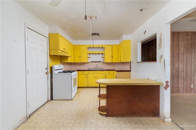 kitchen featuring white range with gas cooktop and sink