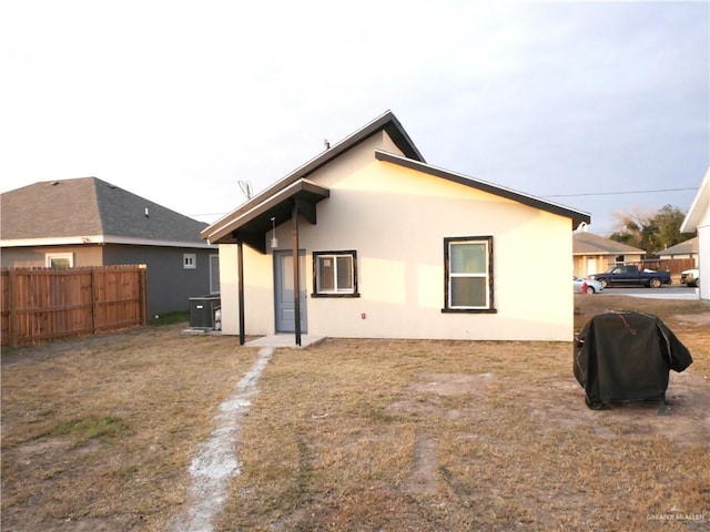 rear view of property featuring central AC unit