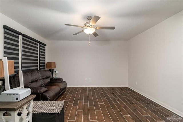 living area with ceiling fan, baseboards, and wood finish floors