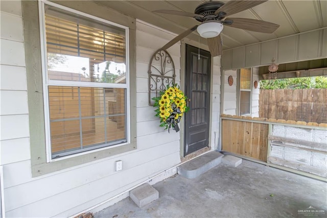 doorway to property featuring ceiling fan