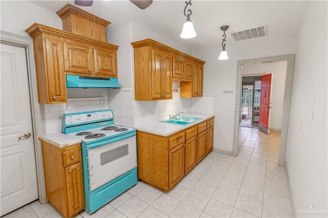 kitchen featuring decorative backsplash, sink, hanging light fixtures, range with electric stovetop, and light tile patterned floors