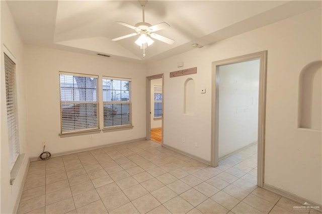 empty room featuring ceiling fan, light tile patterned flooring, and lofted ceiling